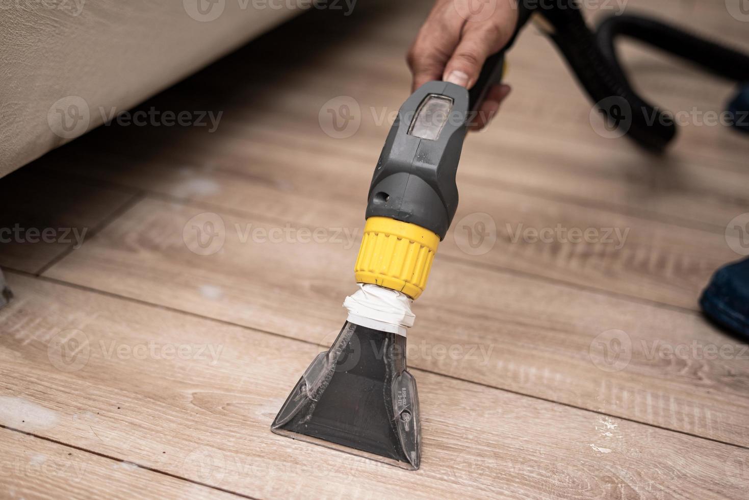 Cleaning a dirty sofa with a sofa washer photo