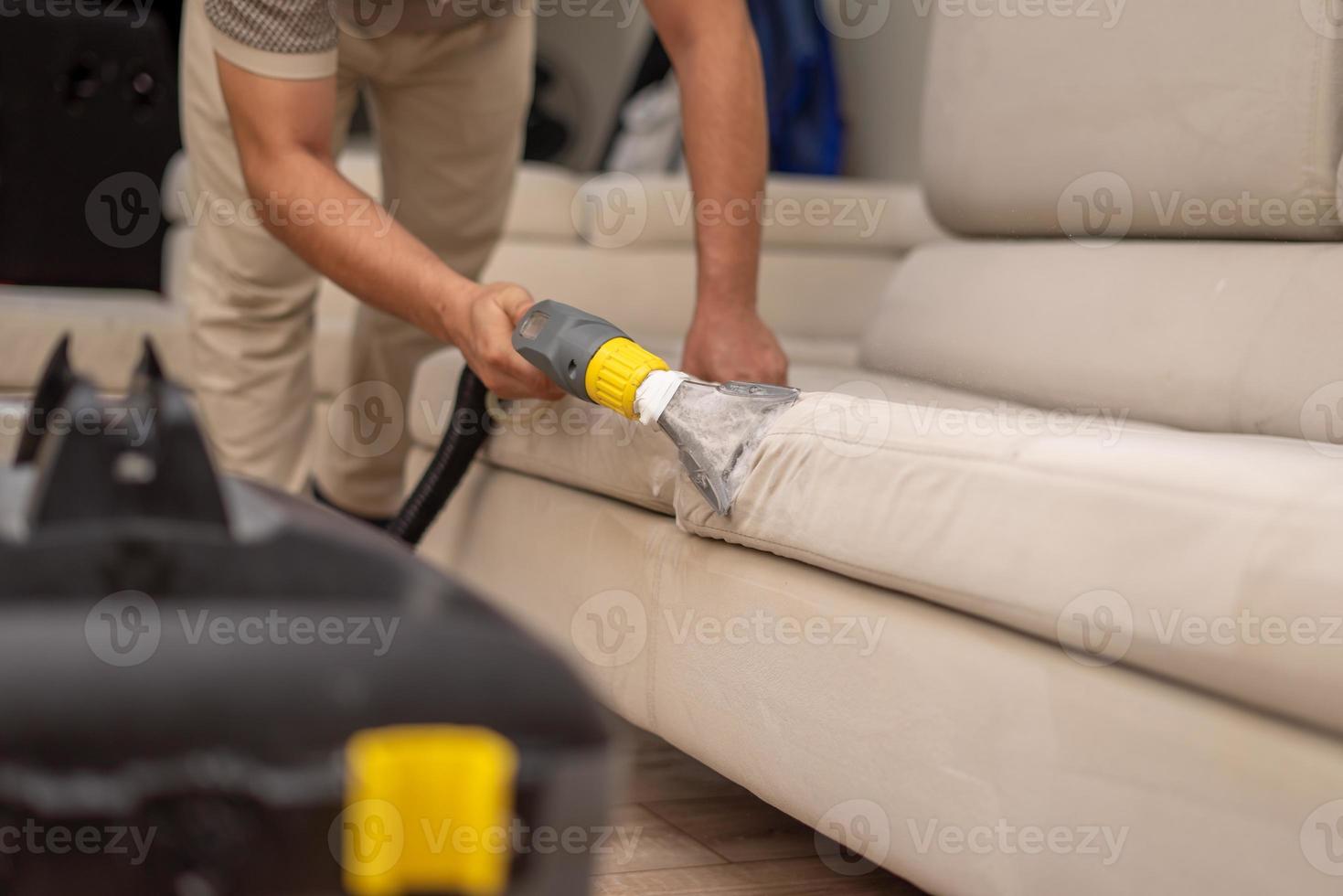 Cleaning a dirty sofa with a sofa washer photo