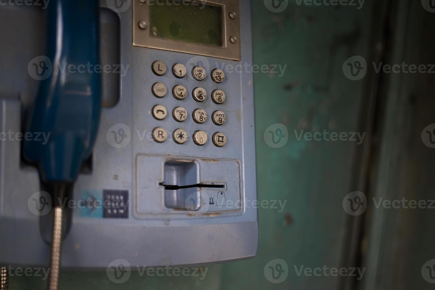 Old blue telephone booth with numbers with cinematic light in Istanbul photo