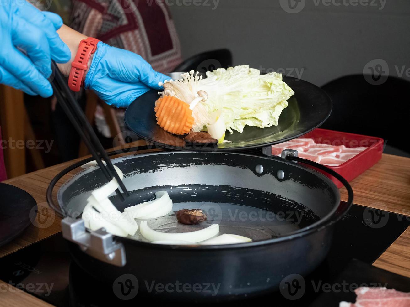 Chef resturant kitchen wear glove mask blue is cooking chopstick shabu suki buffet healthy  vegetable potk seafood beef customer asain japanese korean china eat warm hot for protect covid-19 disease photo