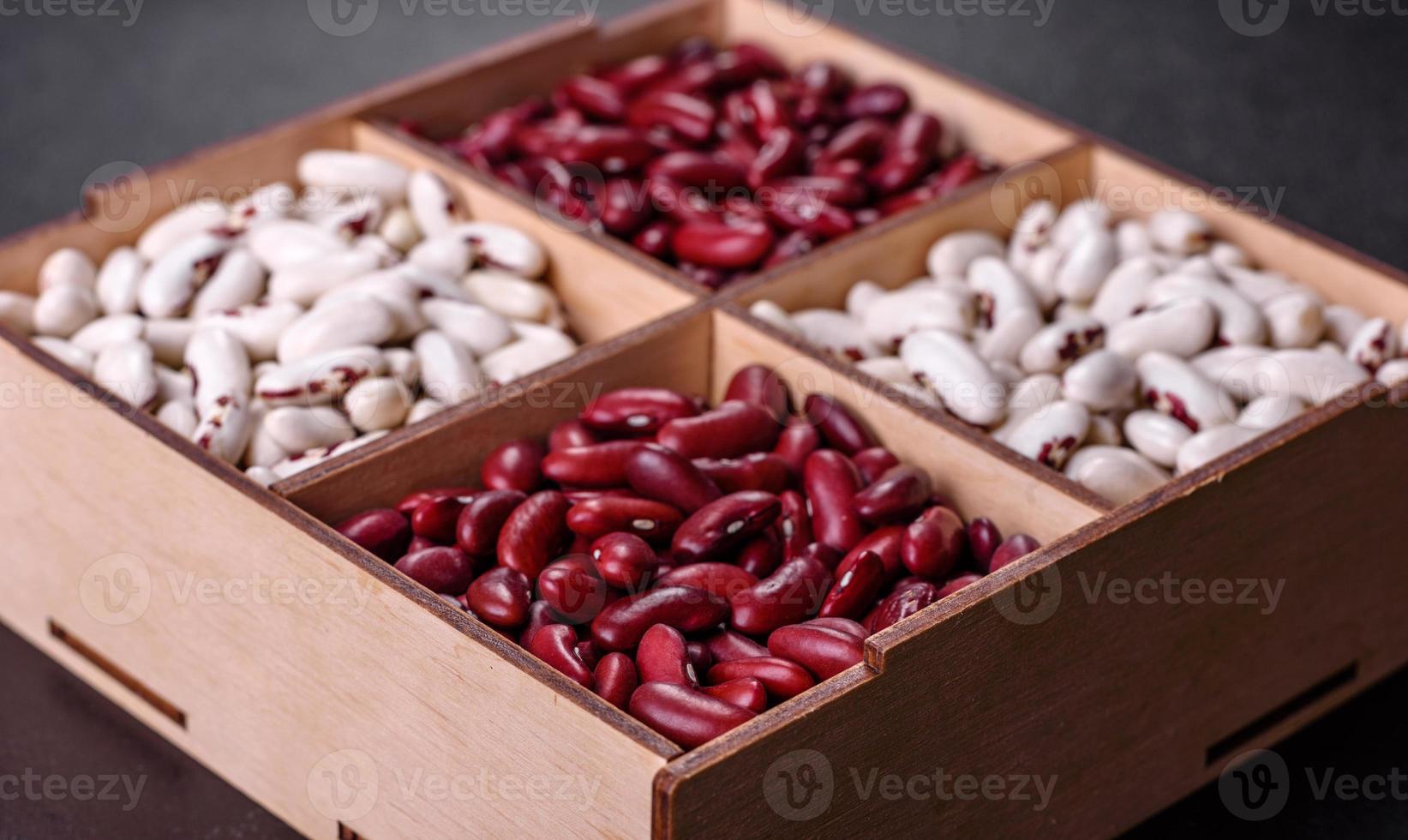 Beans of red and white dry raw beans on a dark concrete background photo