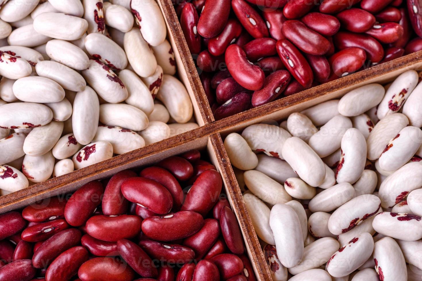 Beans of red and white dry raw beans on a dark concrete background photo