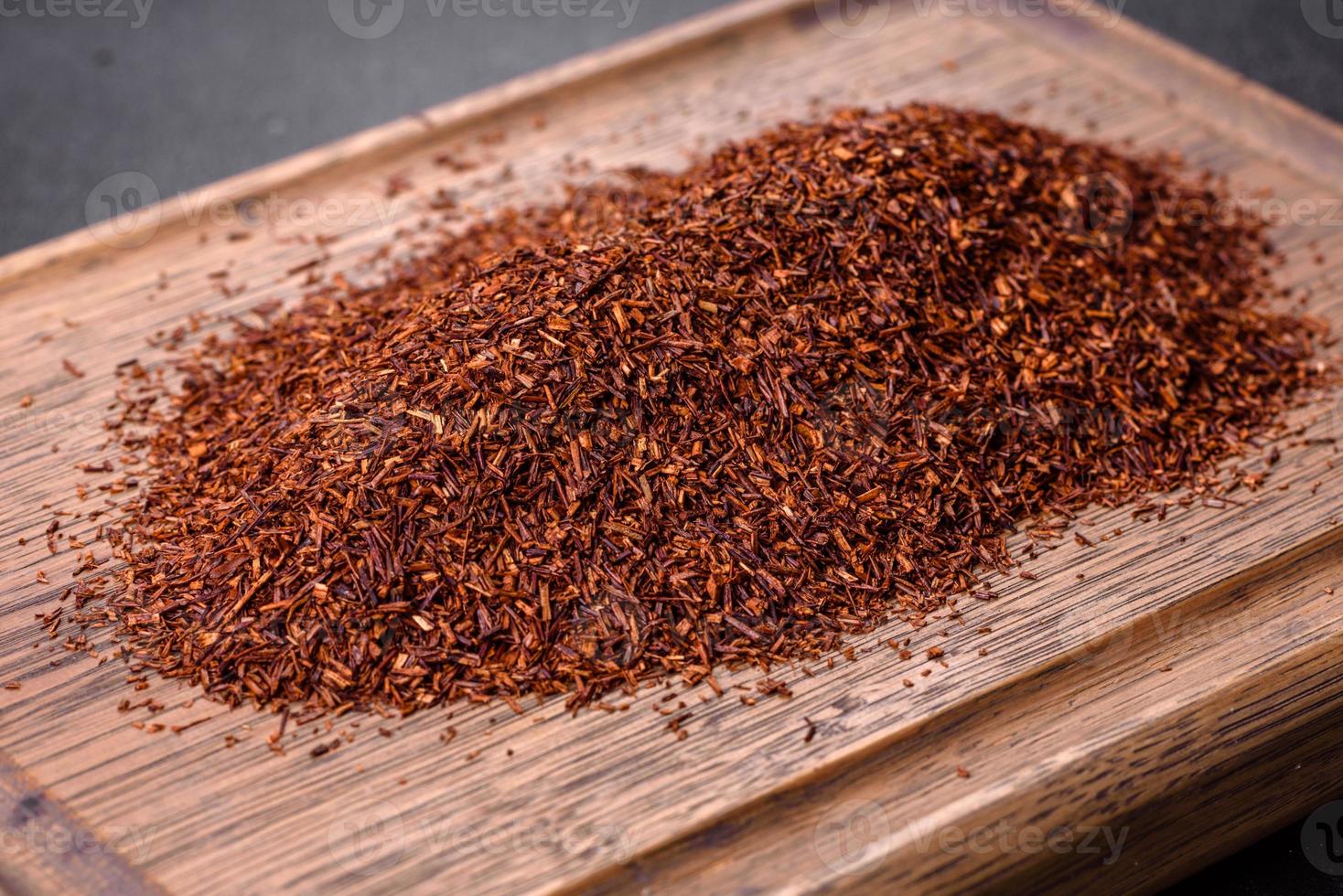 Rooibos tea on a black background. Flat lay, copy space photo