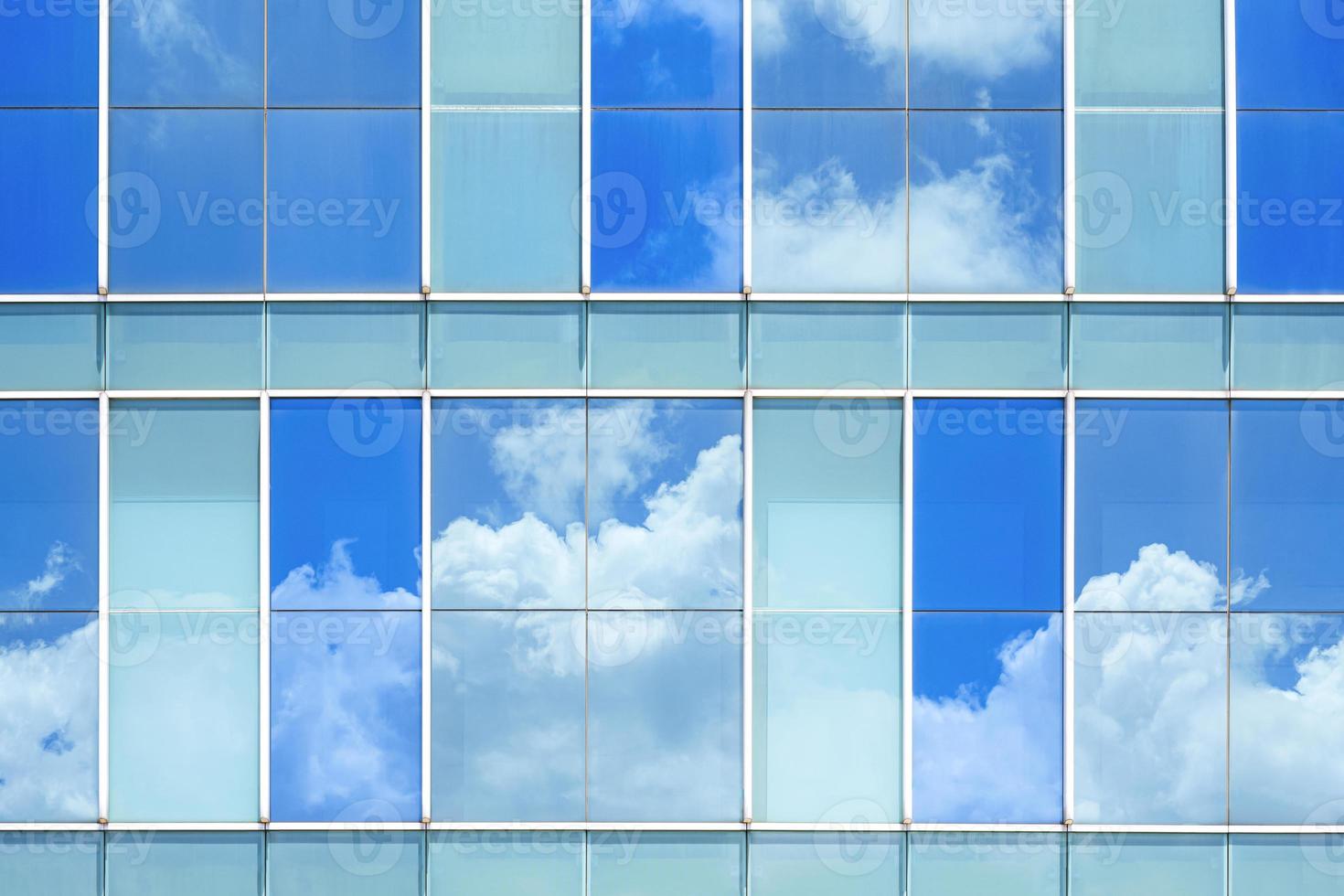 Sky reflection on surface of glass modern building wall photo