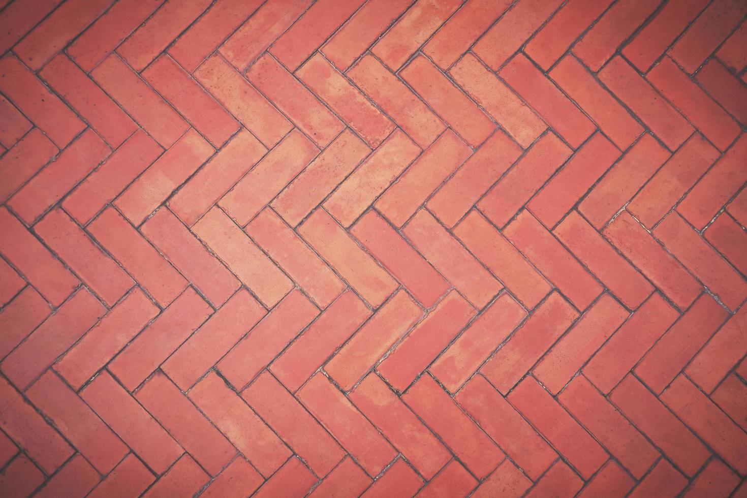 Top view of the old brown bricks floor background in zigzag pattern with vintage tone style photo