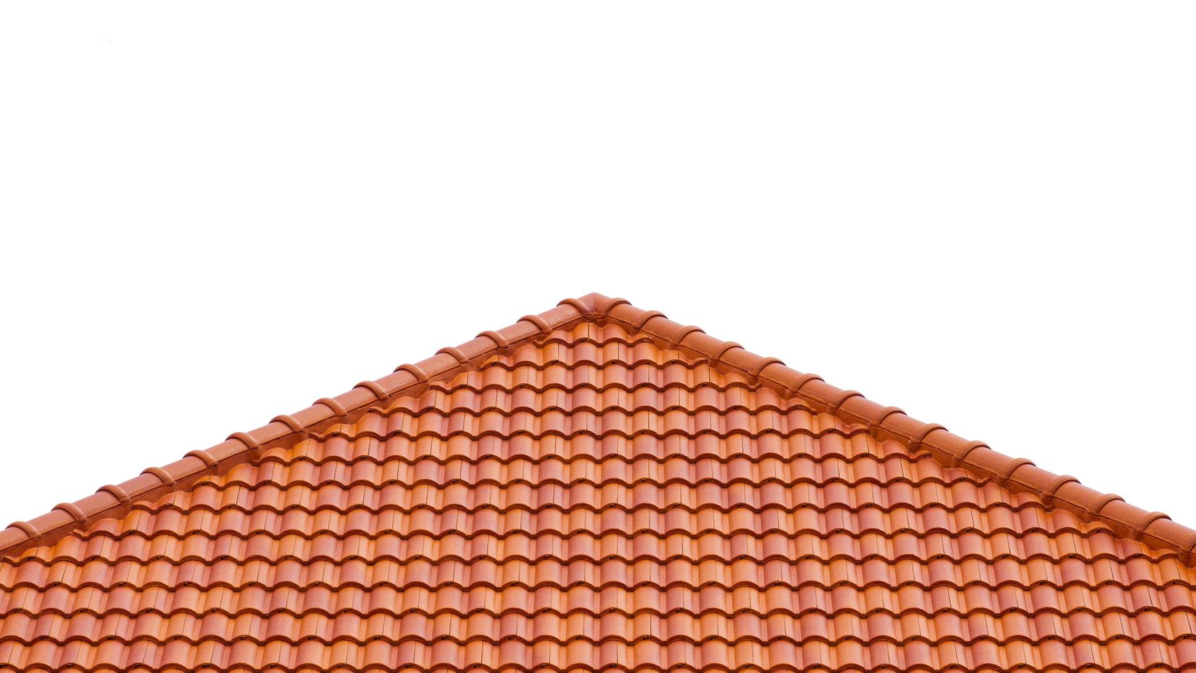 Slope angle view of orange tiles roof on isolated white background photo