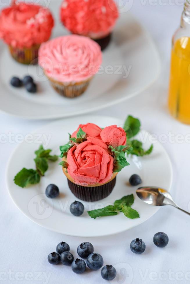 Delicious cupcake on a white plate on a white background. photo