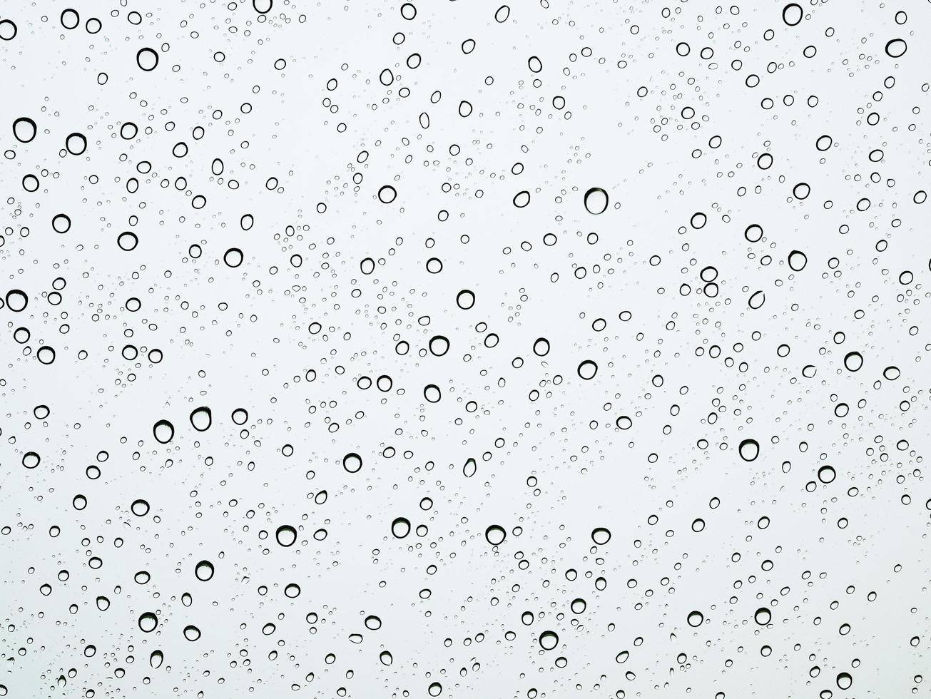 Closeup raindrops on glass car in the rainy season. photo