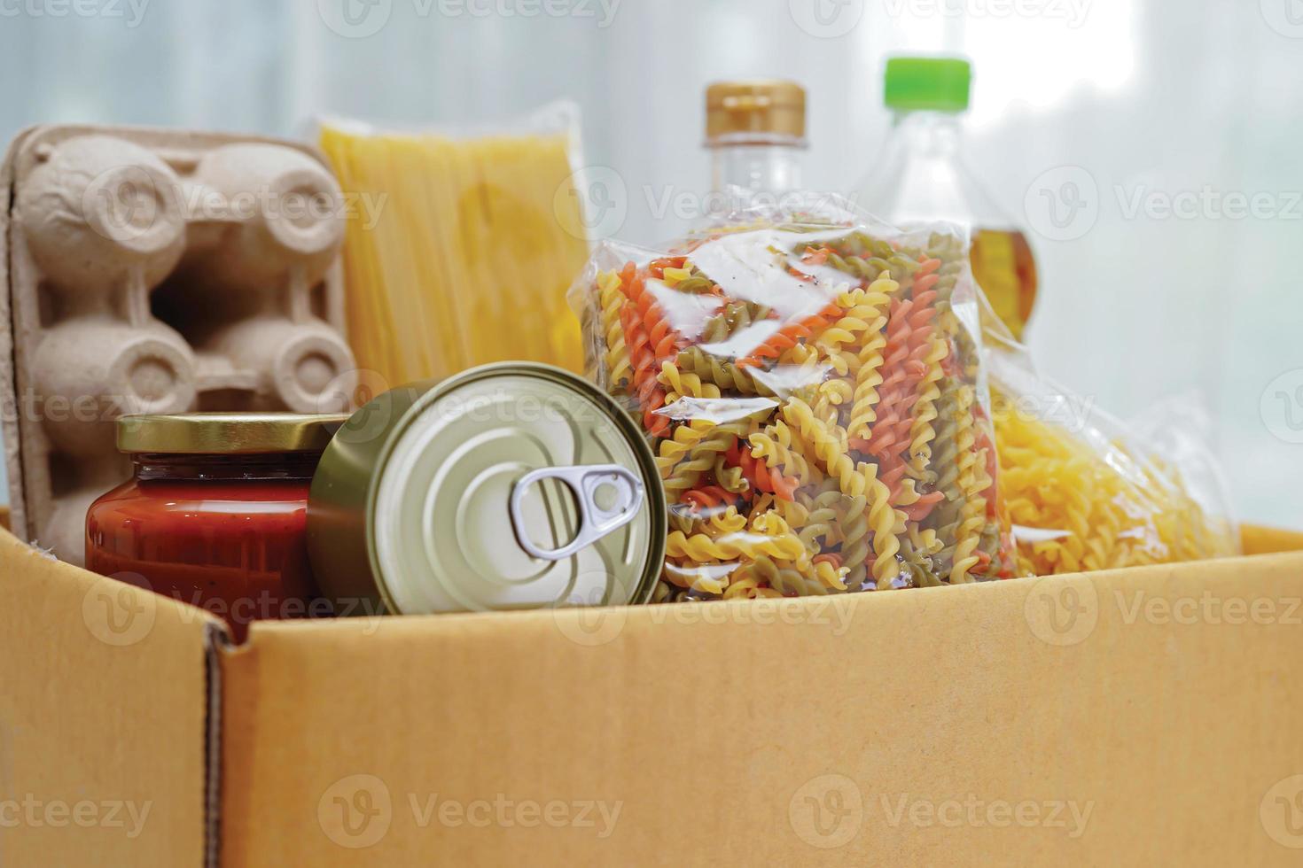 Foodstuffs in donation box for volunteer. photo