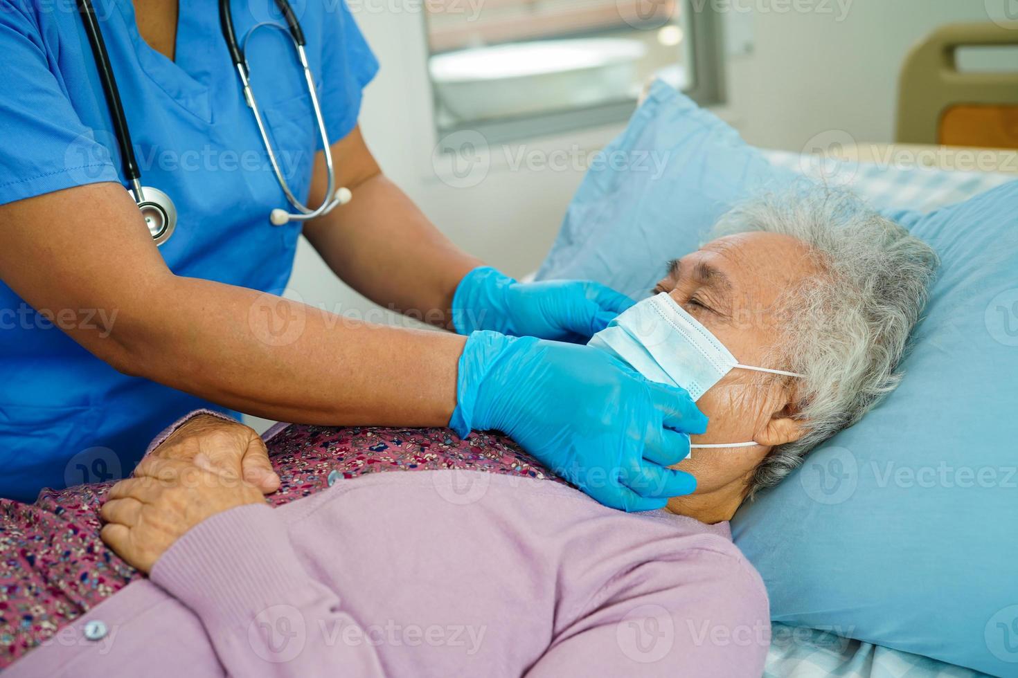 Doctor check Asian elder senior woman patient wearing a mask for protect covid coronavirus. photo