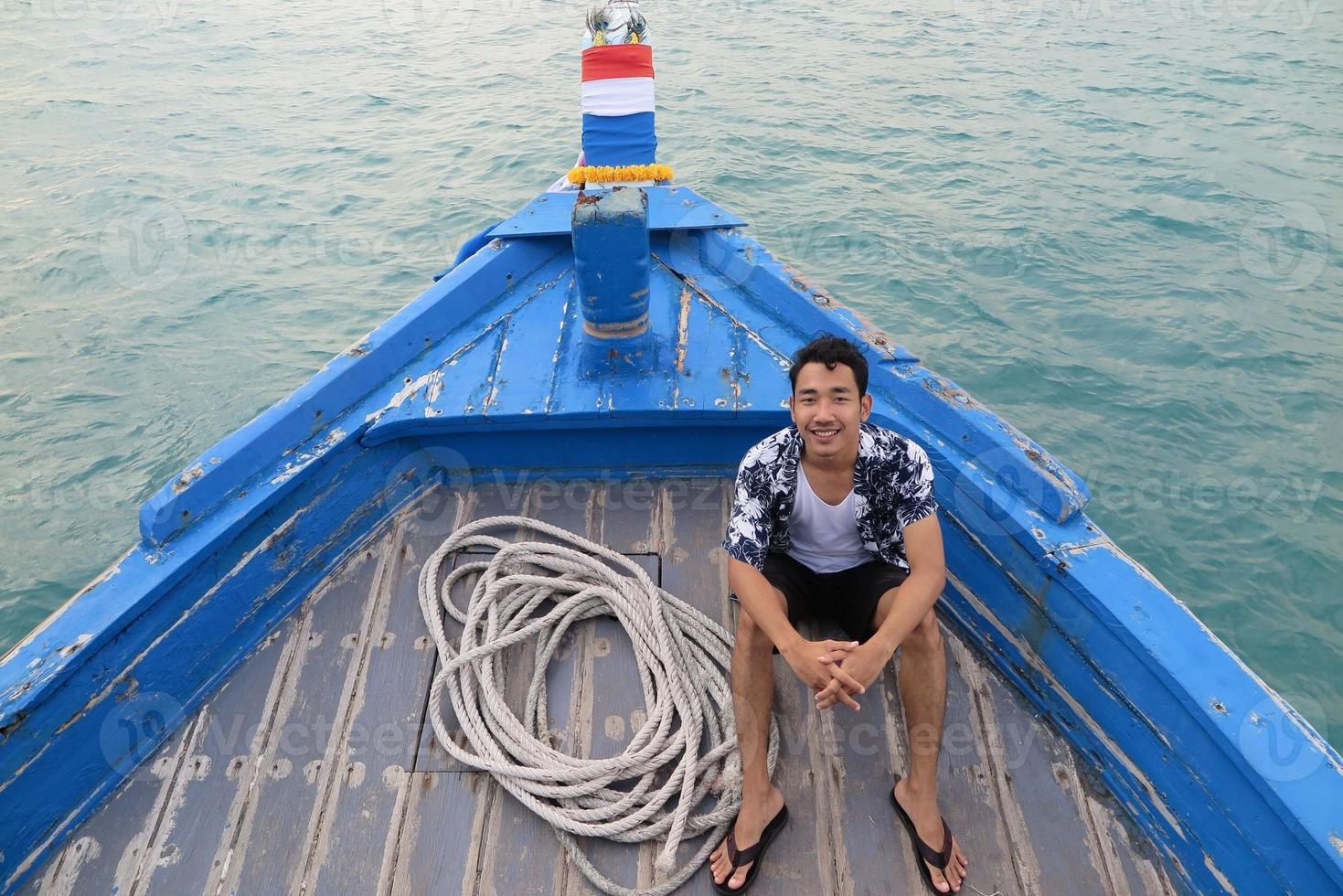 Man on wooden boat photo