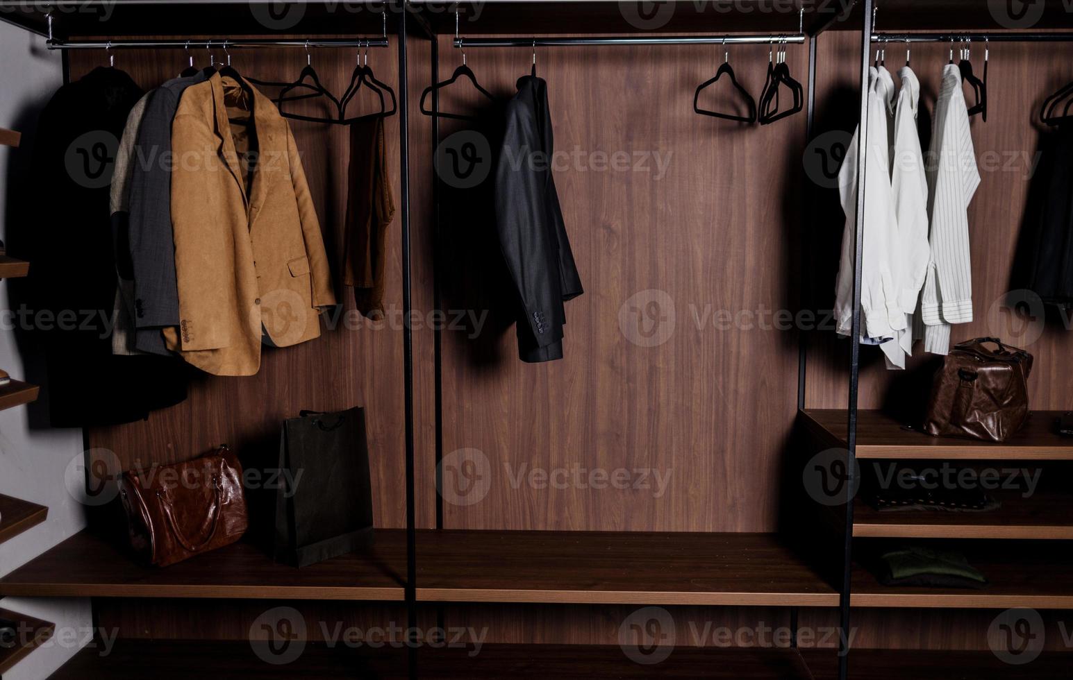 Row of men's suits and shirt photo