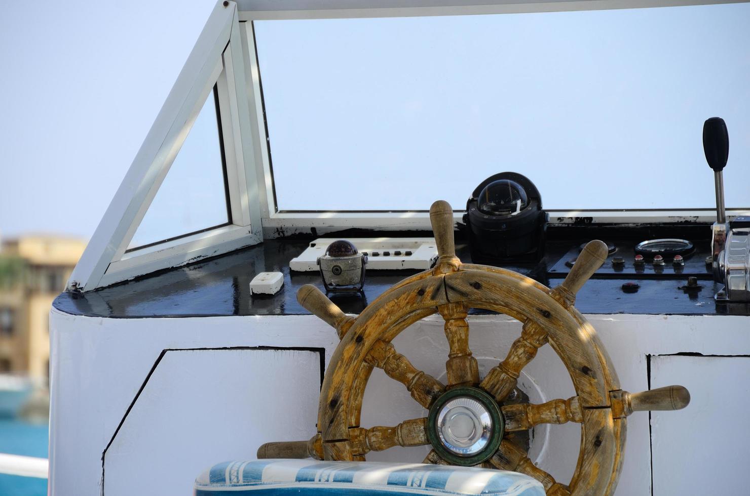 wooden steering wheel of boat photo