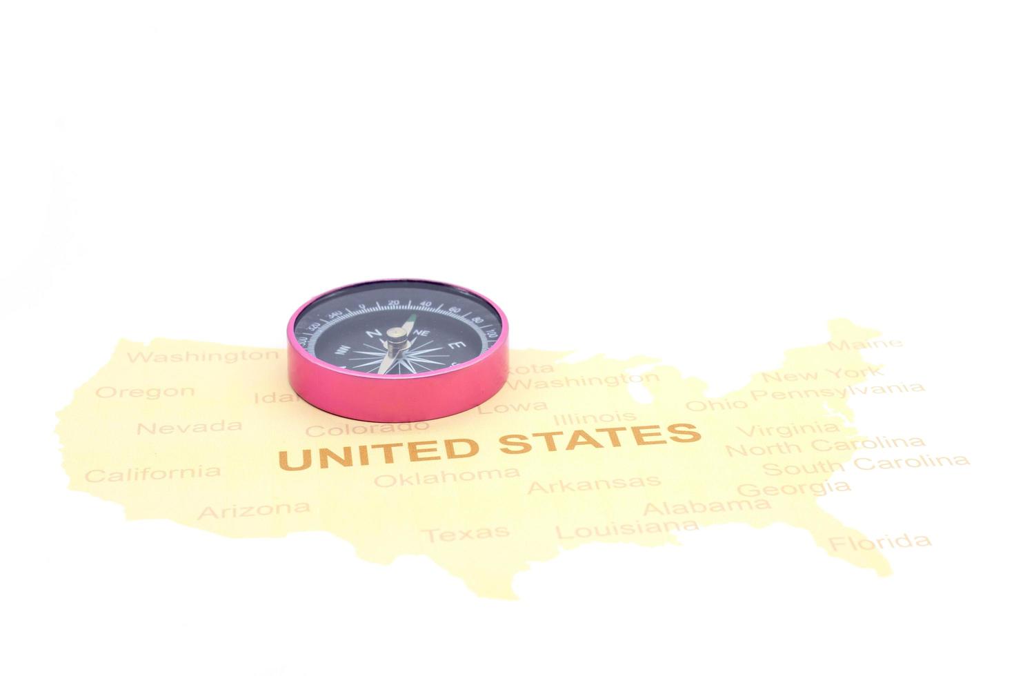 compass and coins on a American map. business travel concept photo