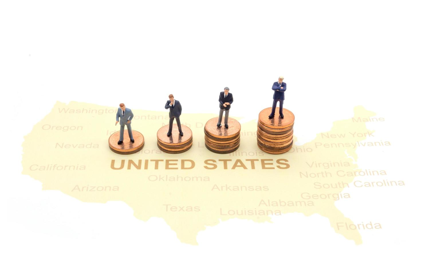 Miniature people, businessman standing on map American photo