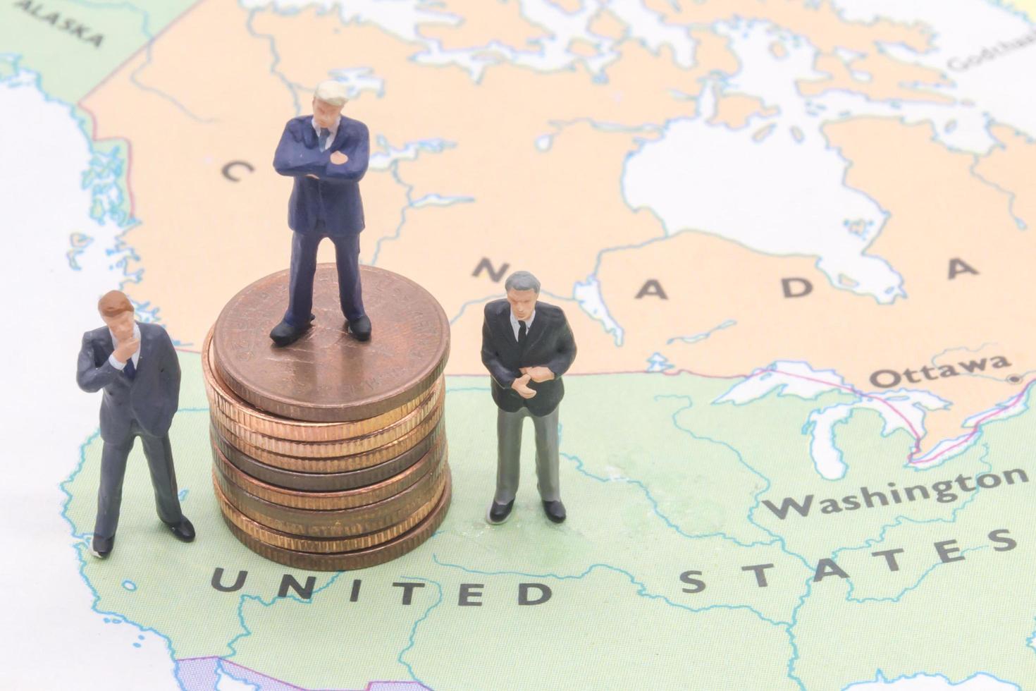 Miniature people, businessman standing on map American photo