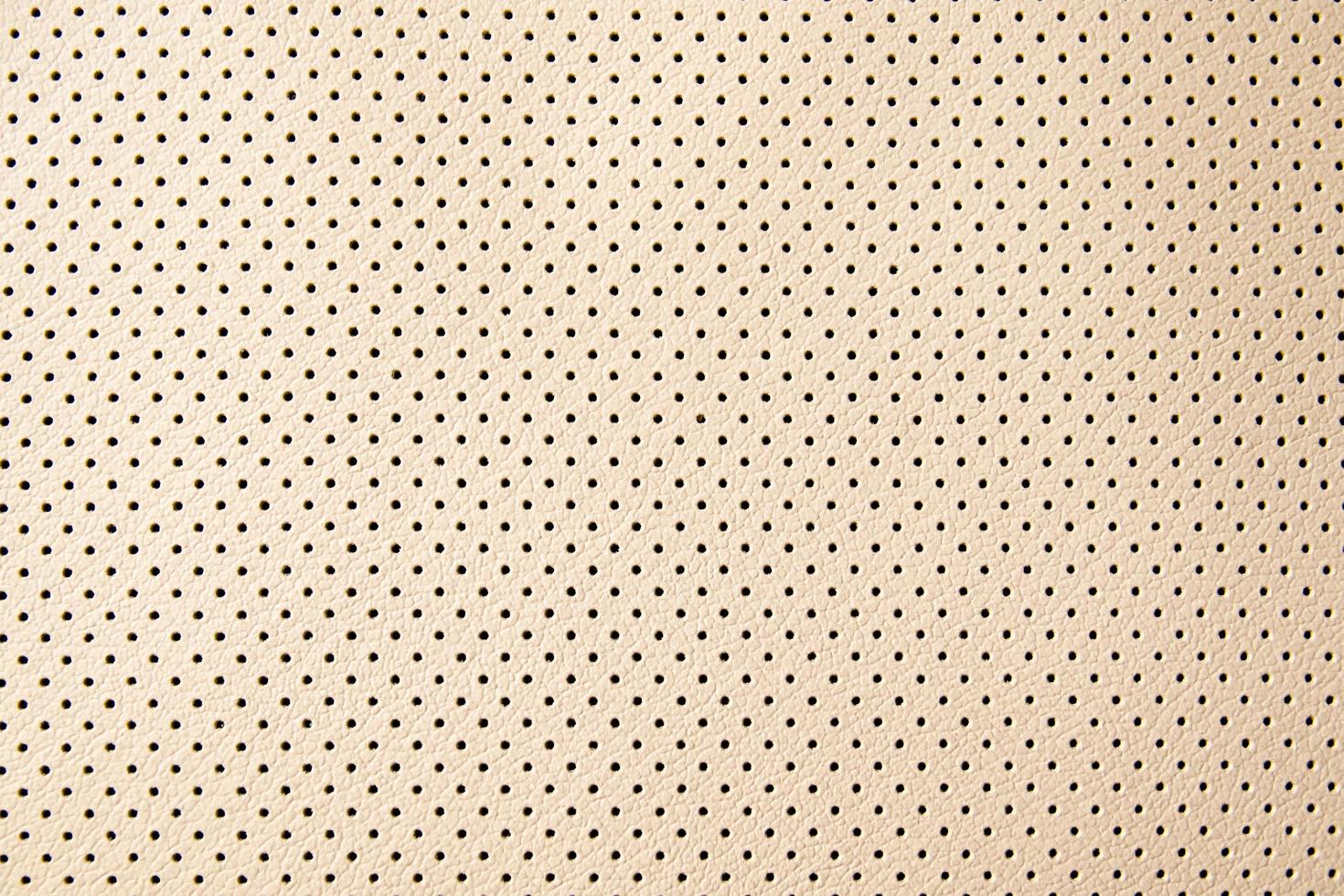 leather texture with small black holes photo