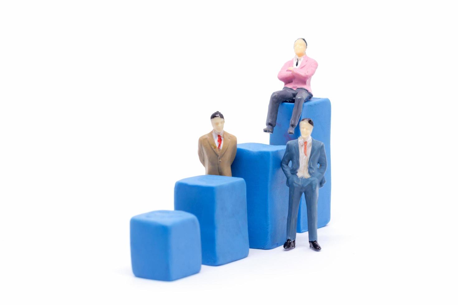 Miniature businessman and graph on white background, Business Growth concept photo