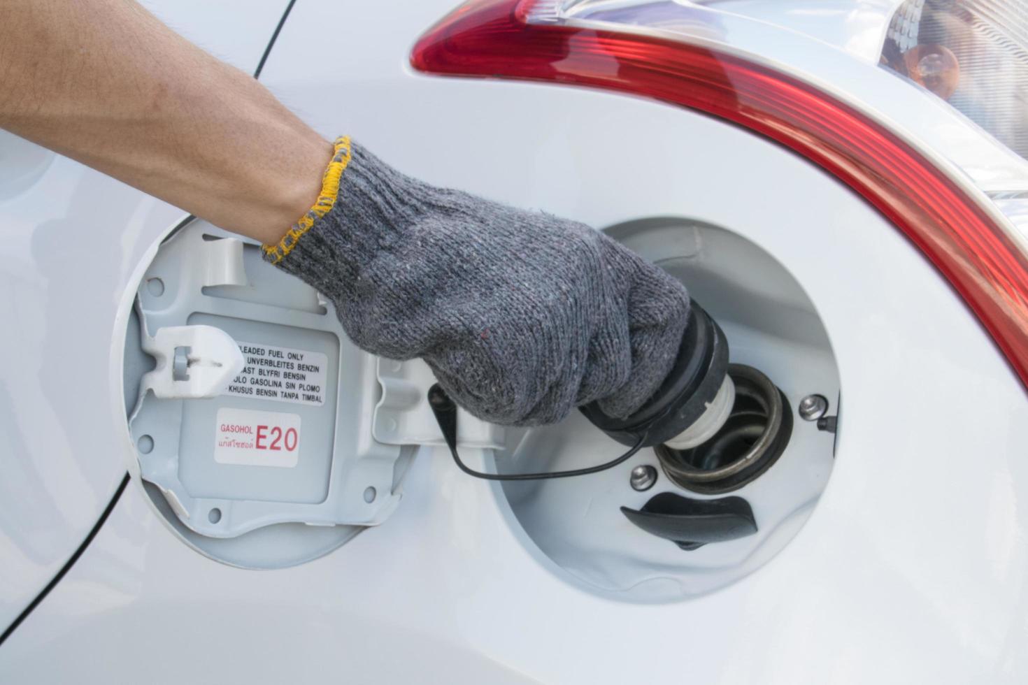 Hand opening the oil filler cap photo