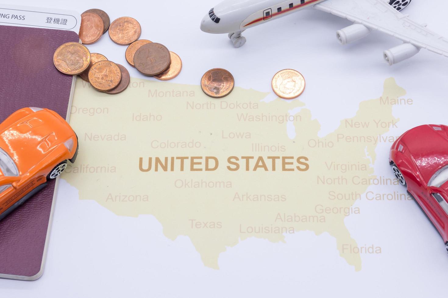 passport compass and coins on a American map. business travel concept photo