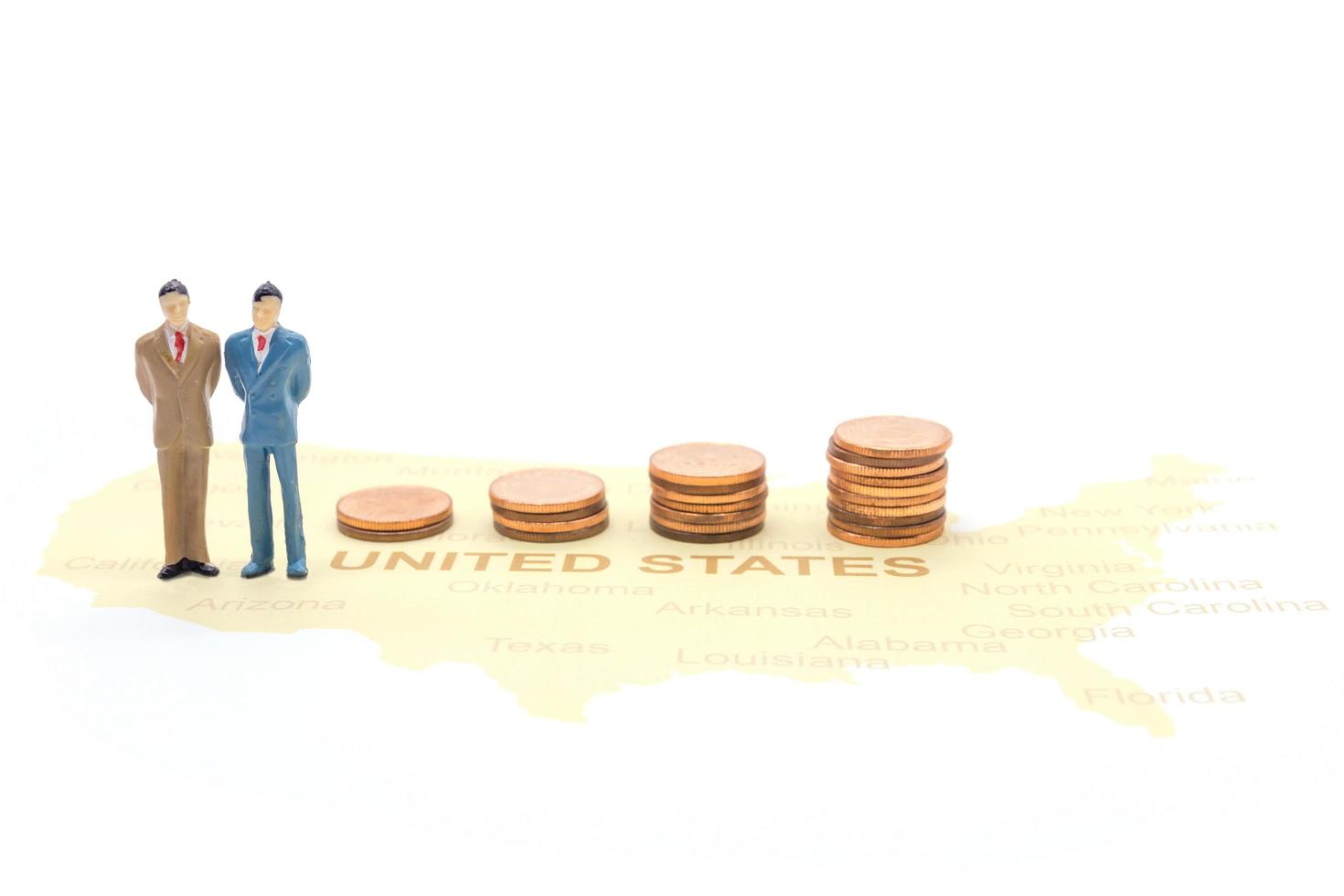 Miniature people, businessman standing on map American photo