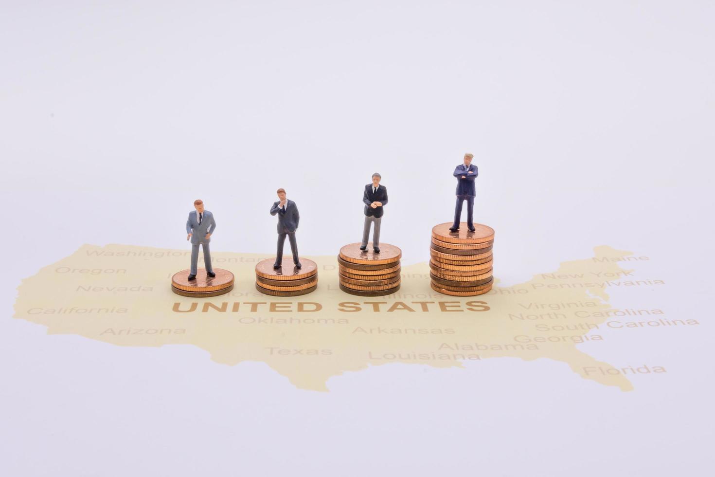 Miniature people, businessman standing on map American photo