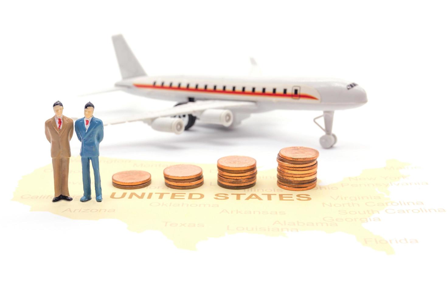 Miniature people, businessman standing on map American photo