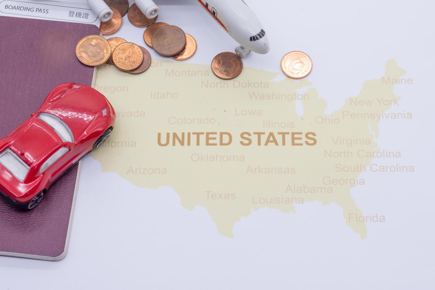 passport compass and coins on a American map. business travel concept photo