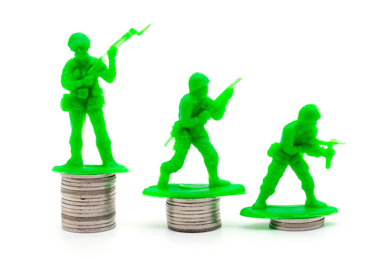 Toy Soldier on coin stacks a white background photo