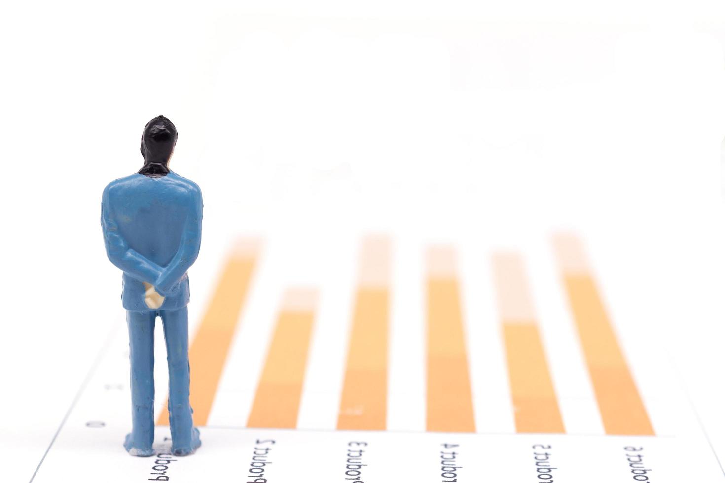 Miniature figures businessmen standing on a graph chart financial photo