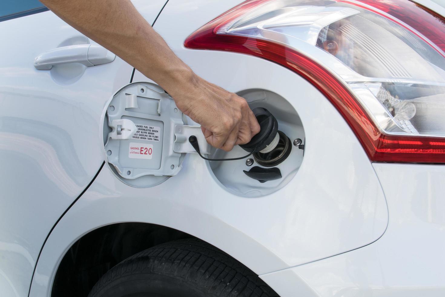 Hand opening the oil filler cap photo