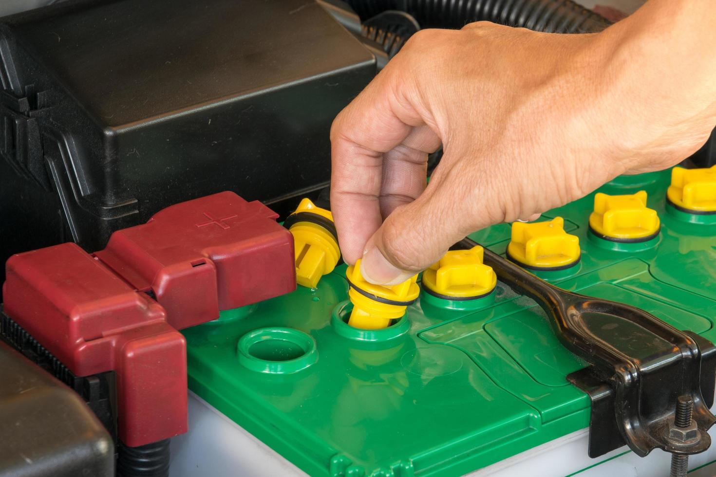 mechanic the battery of a car photo