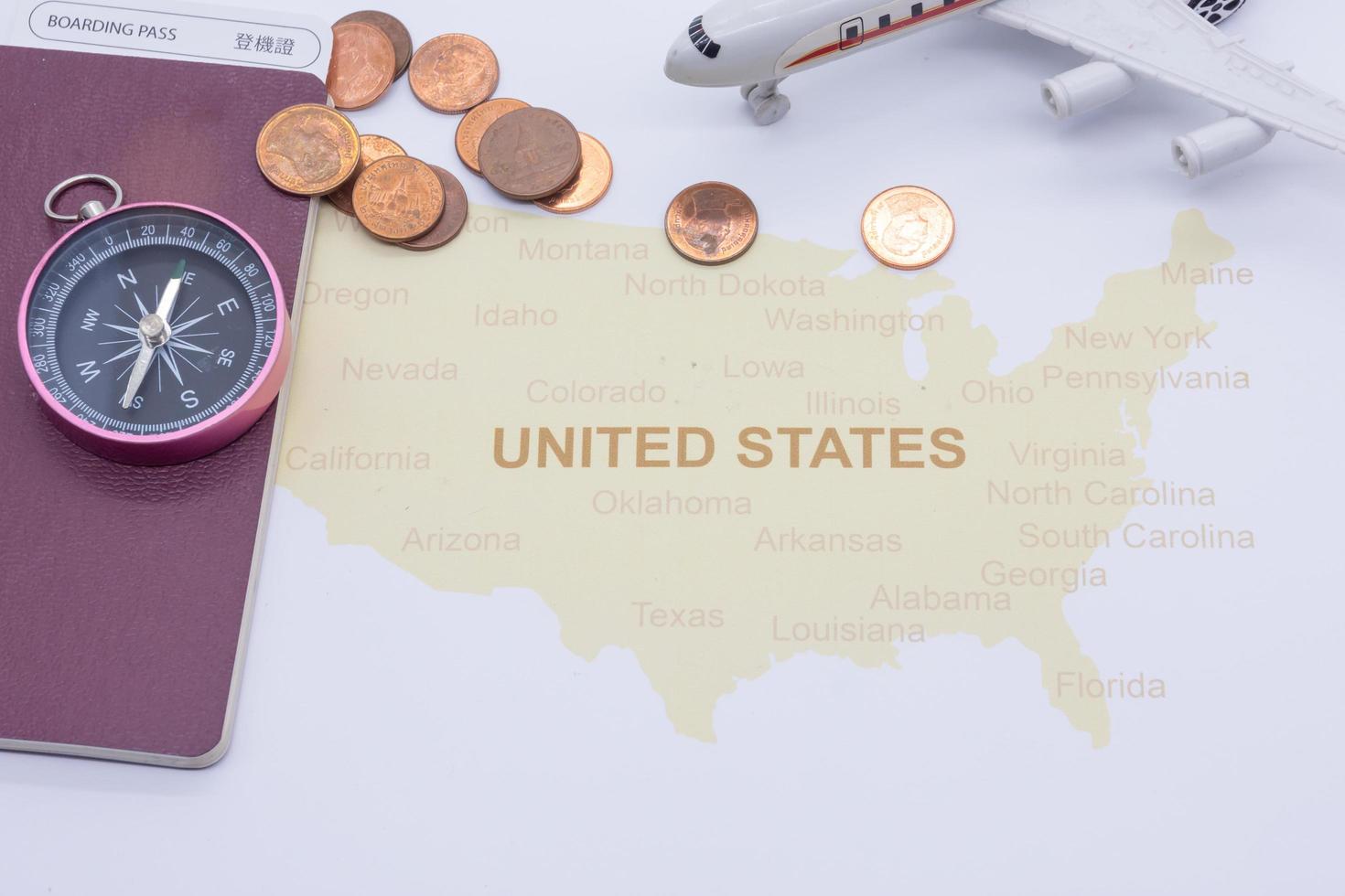 passport compass and coins on a American map. business travel concept photo