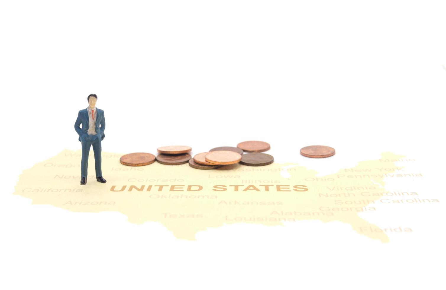 Miniature people, businessman standing on map American photo