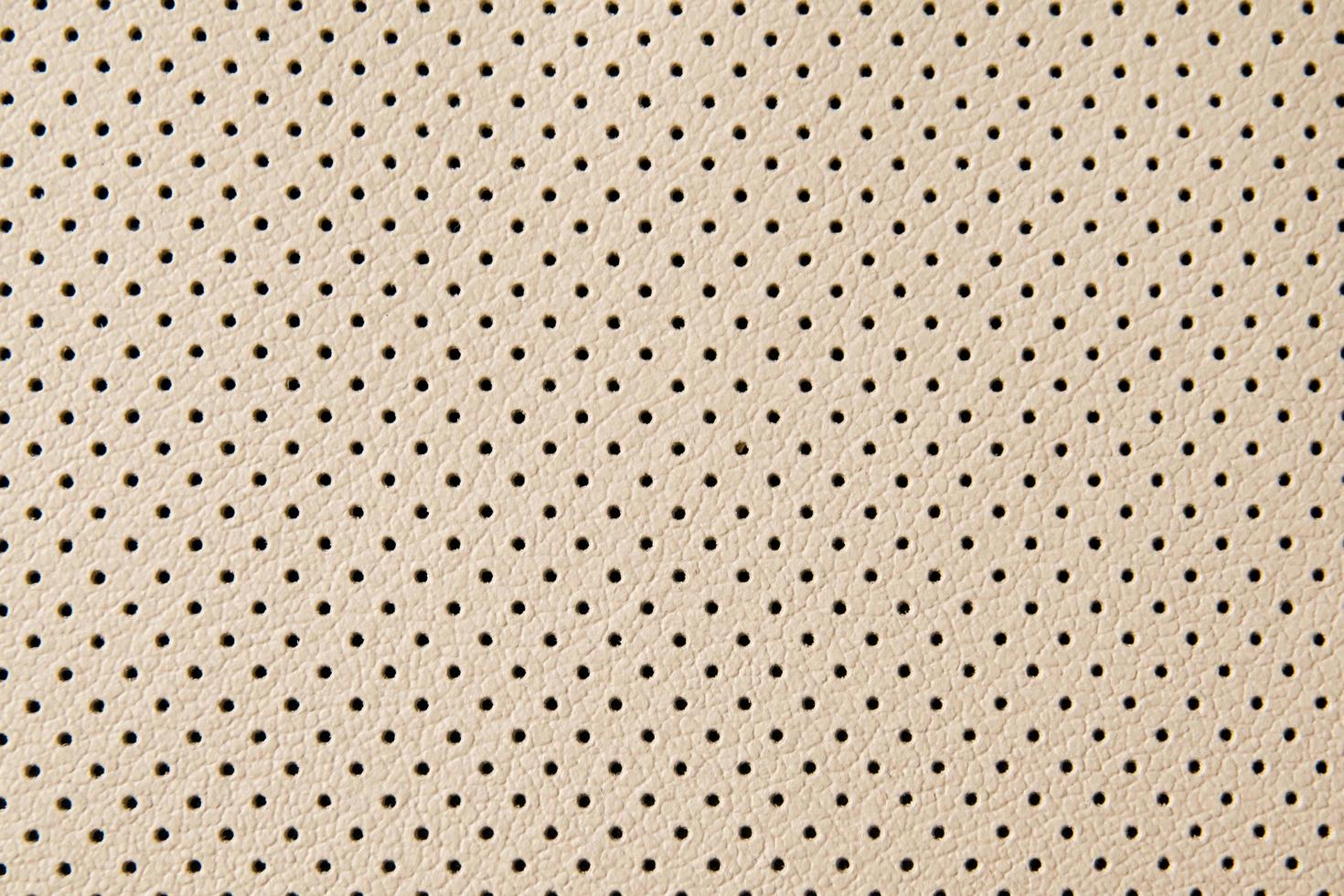 leather texture with small black holes photo