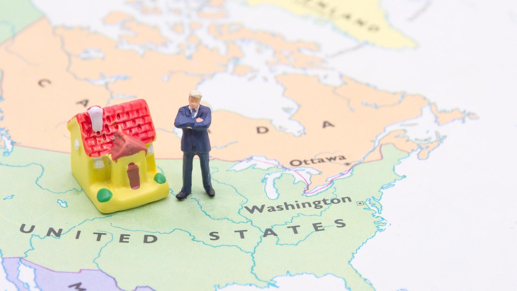 Businessman and house on map American. Miniature people photo