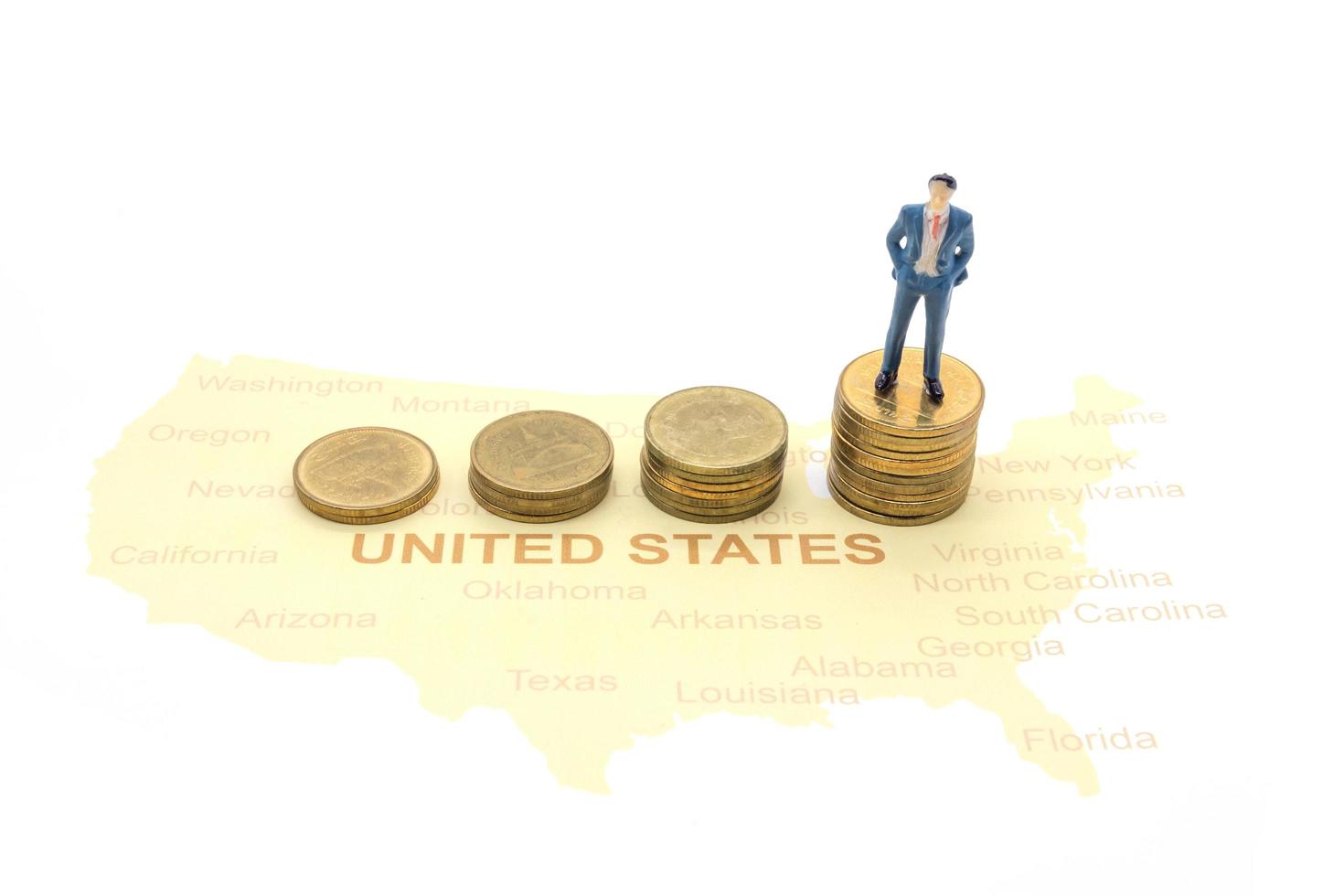 Miniature people, businessman standing on map American photo