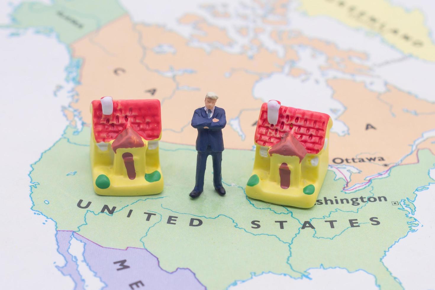 Businessman and house on map American. Miniature people photo