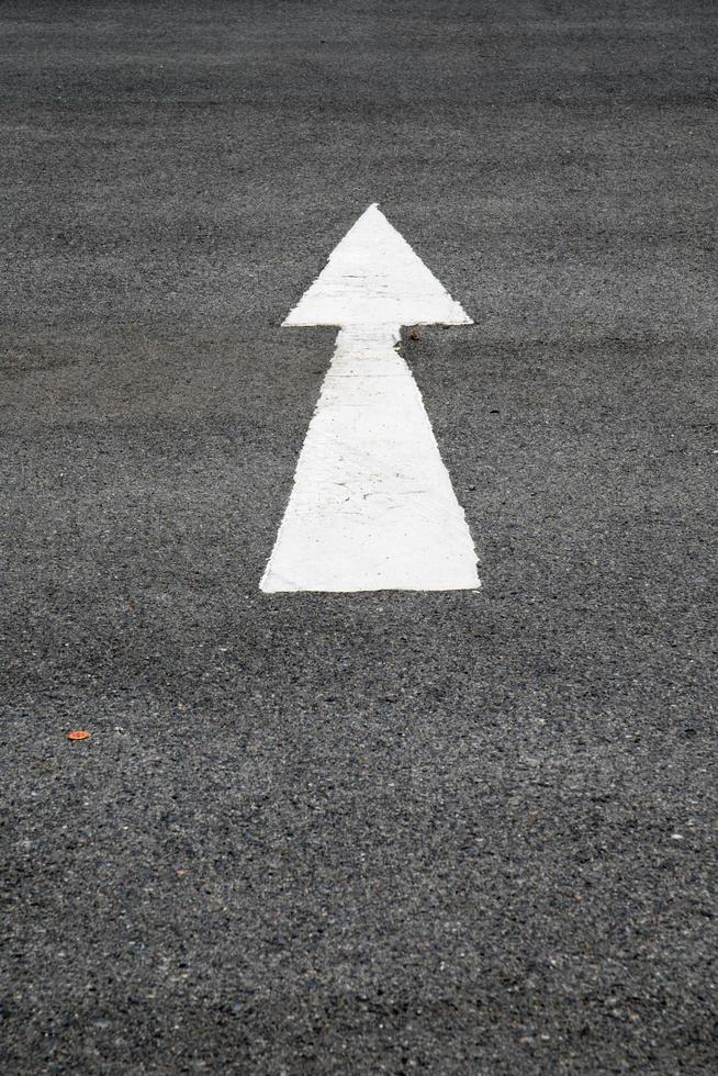 arrows painted on a cement floor. photo