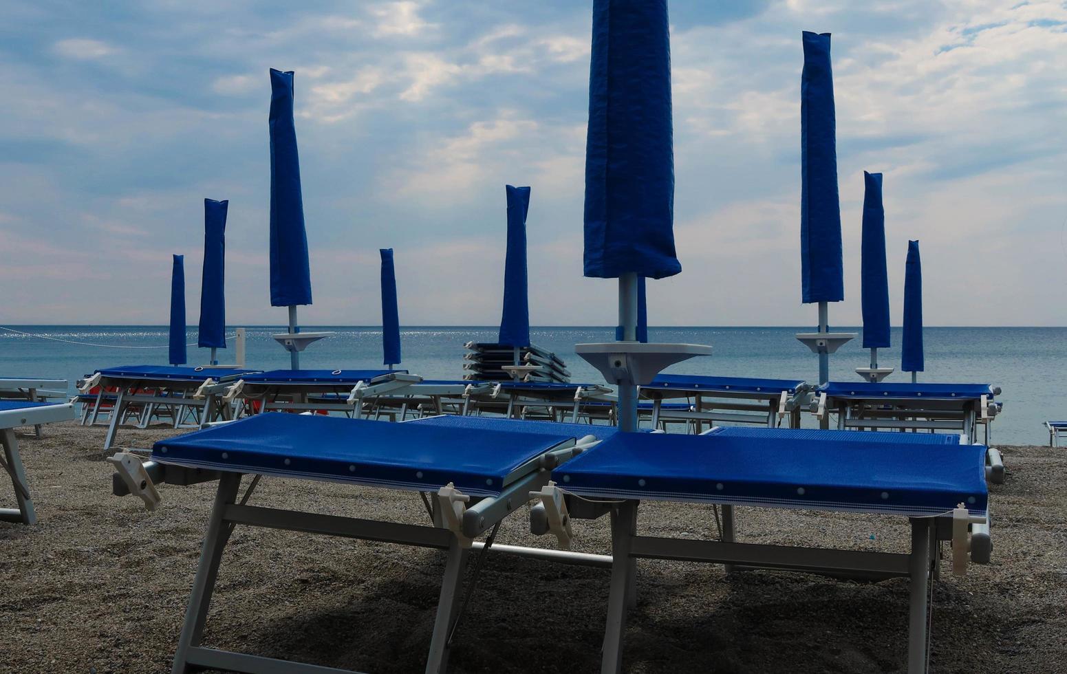 deckchairs on the sandy beach near the sea in July, in Spotorno on the western Ligurian Riviera photo