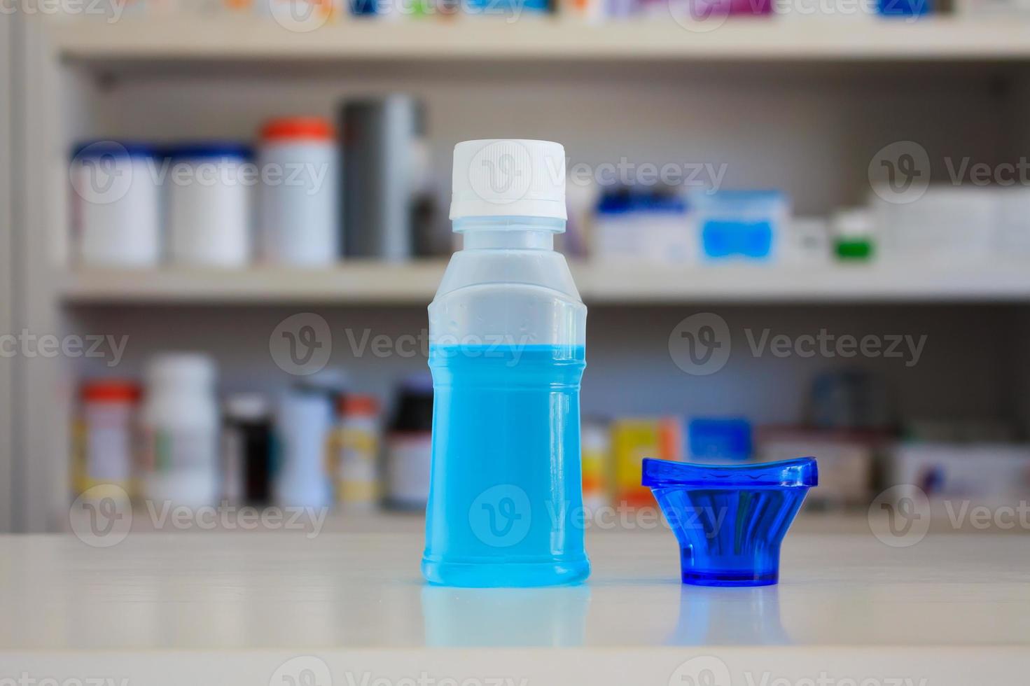 eye cleansing lotion bottle on the counter with blur drugstore shelves background photo
