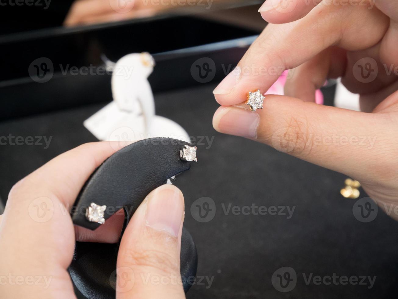 Woman hands hold Diamond earrings photo