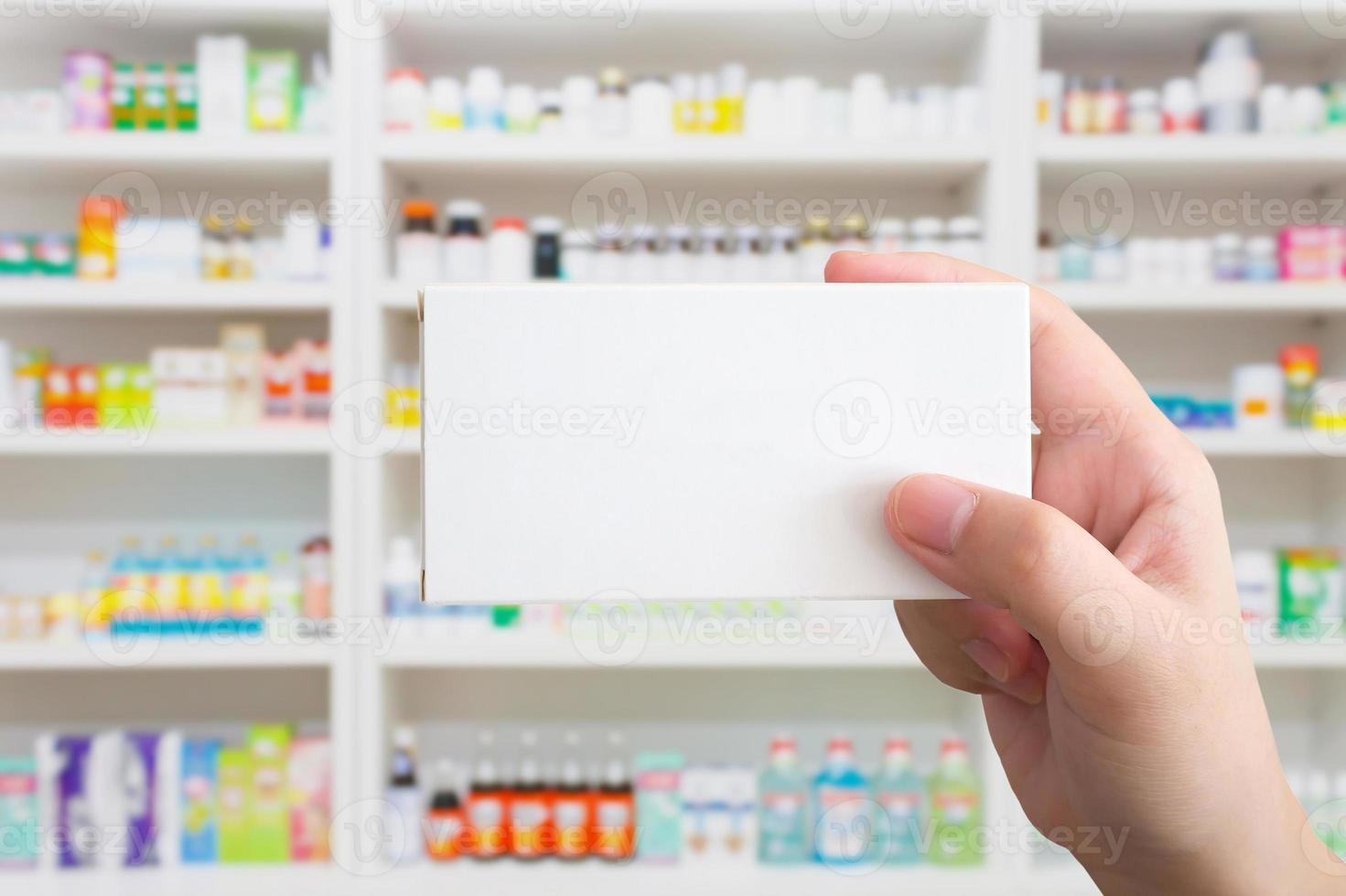Close up pharmacist hand hold medicine box package photo