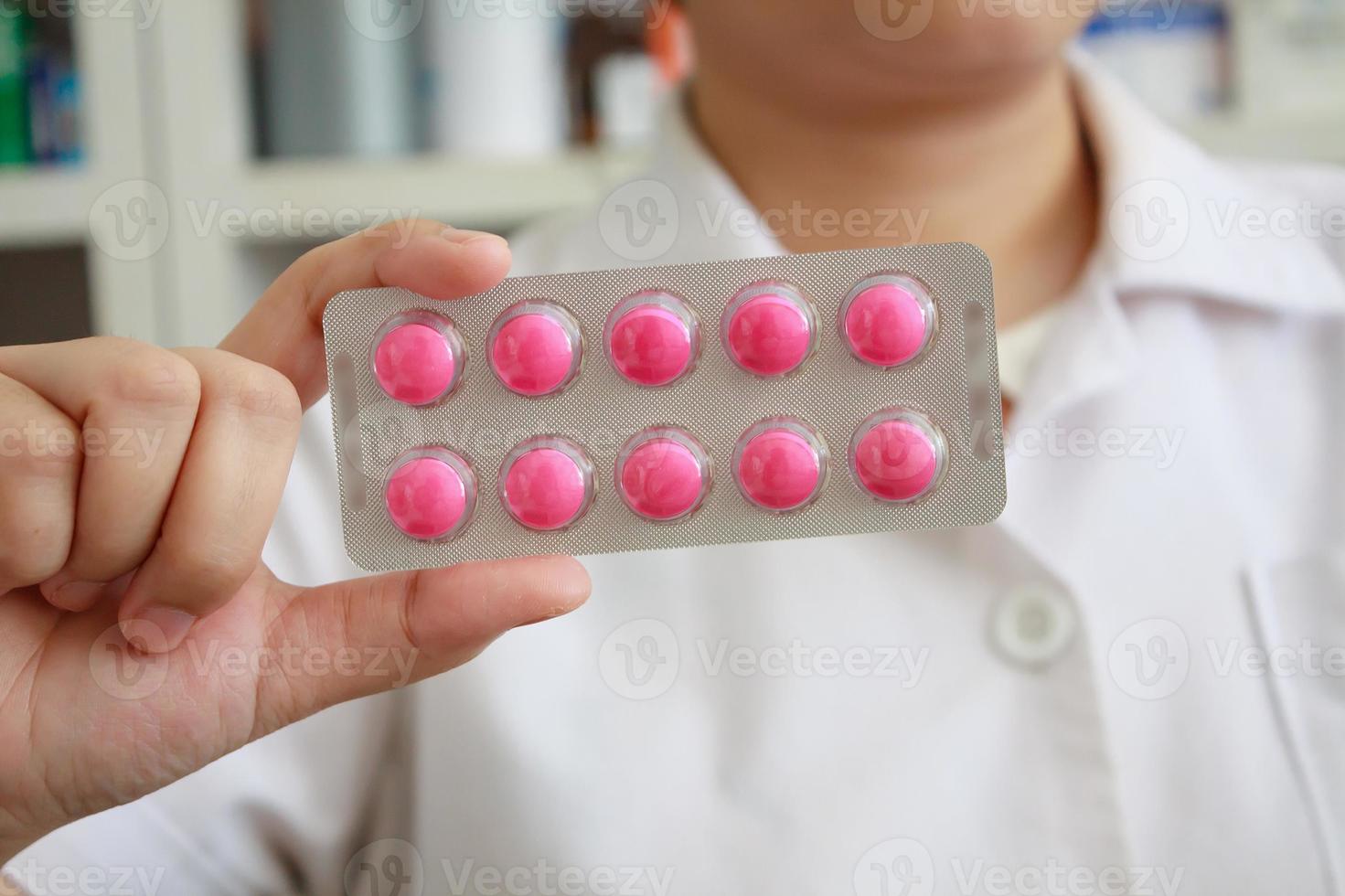 pharmacist with pills over pharmacy store background photo