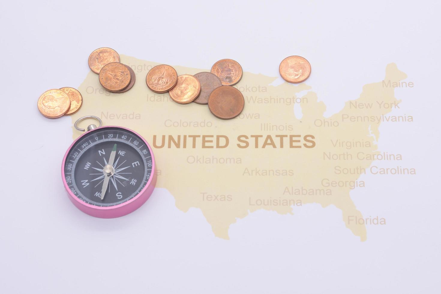 passport compass and coins on a American map. business travel concept photo