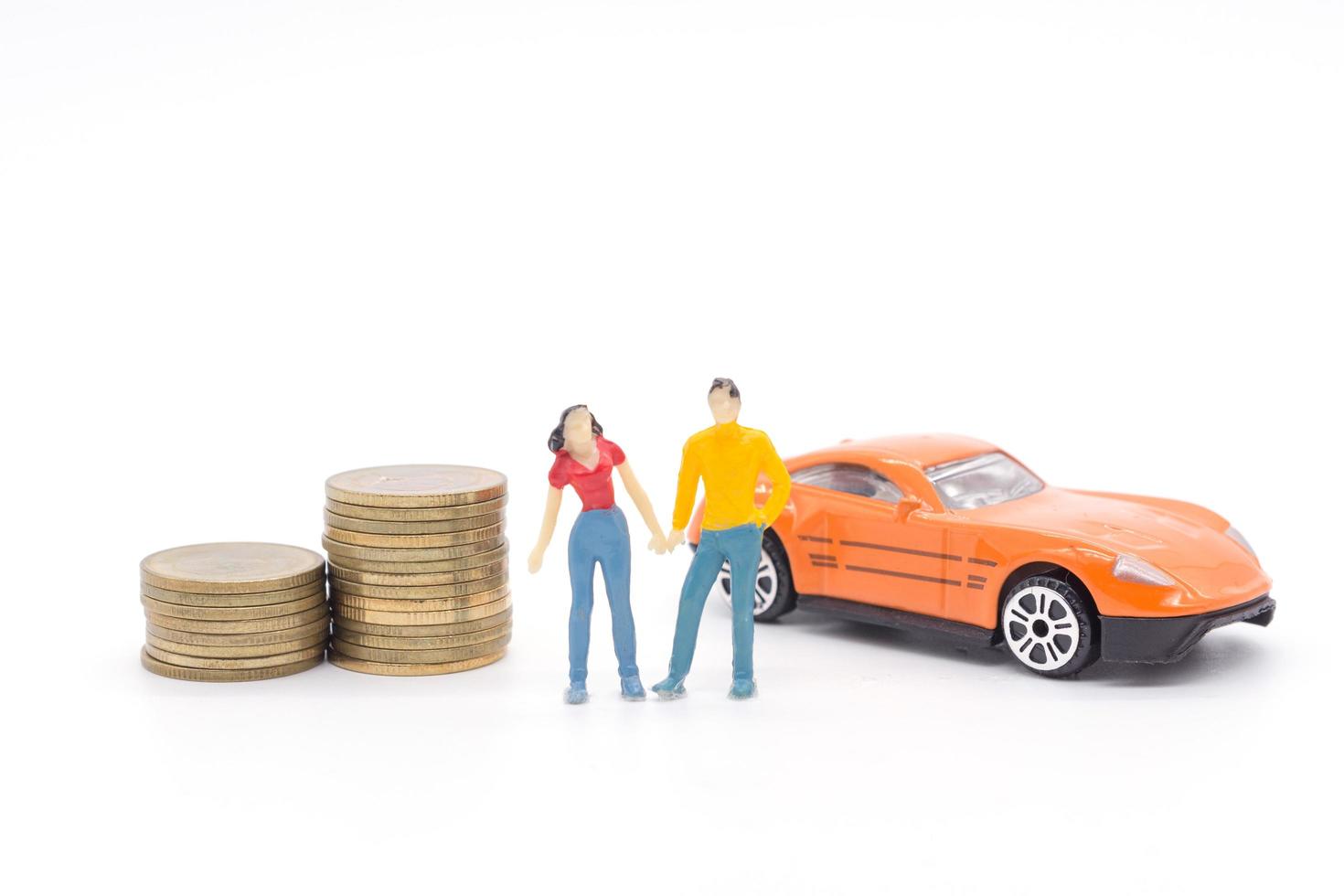 Miniature people,husband and wife standing with car and stack coins. saving and loan concept. photo