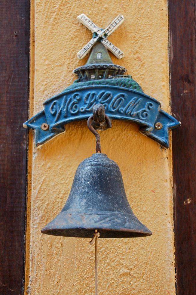 bronze bell with wood wall welcome customer photo