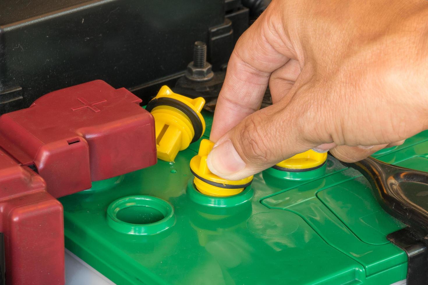 mechanic the battery of a car photo