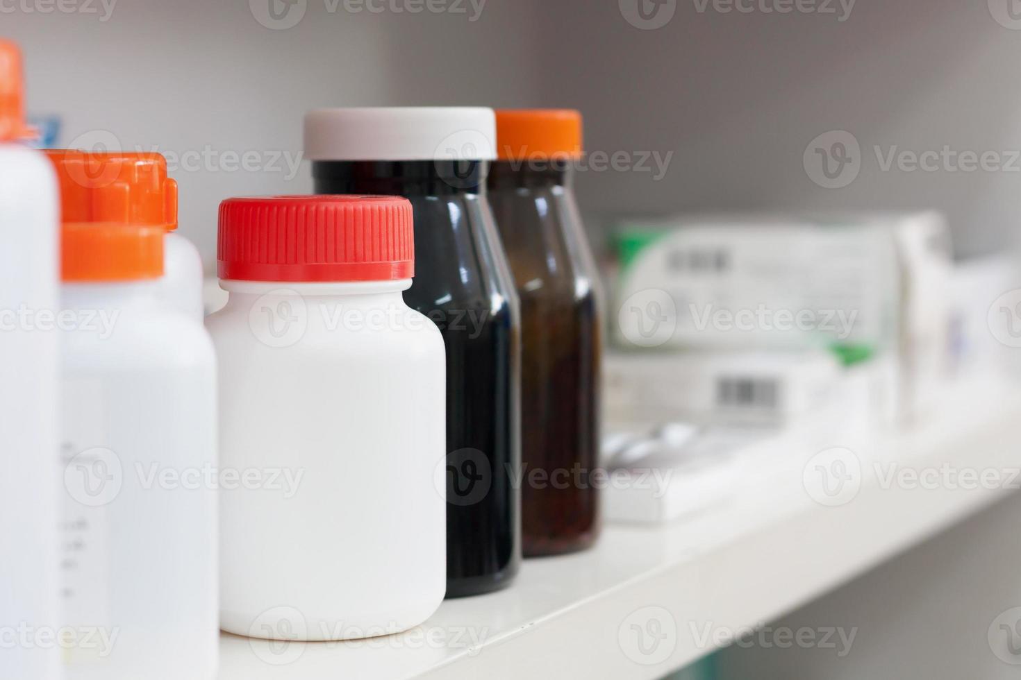 bottles on pharmacy store shelf photo