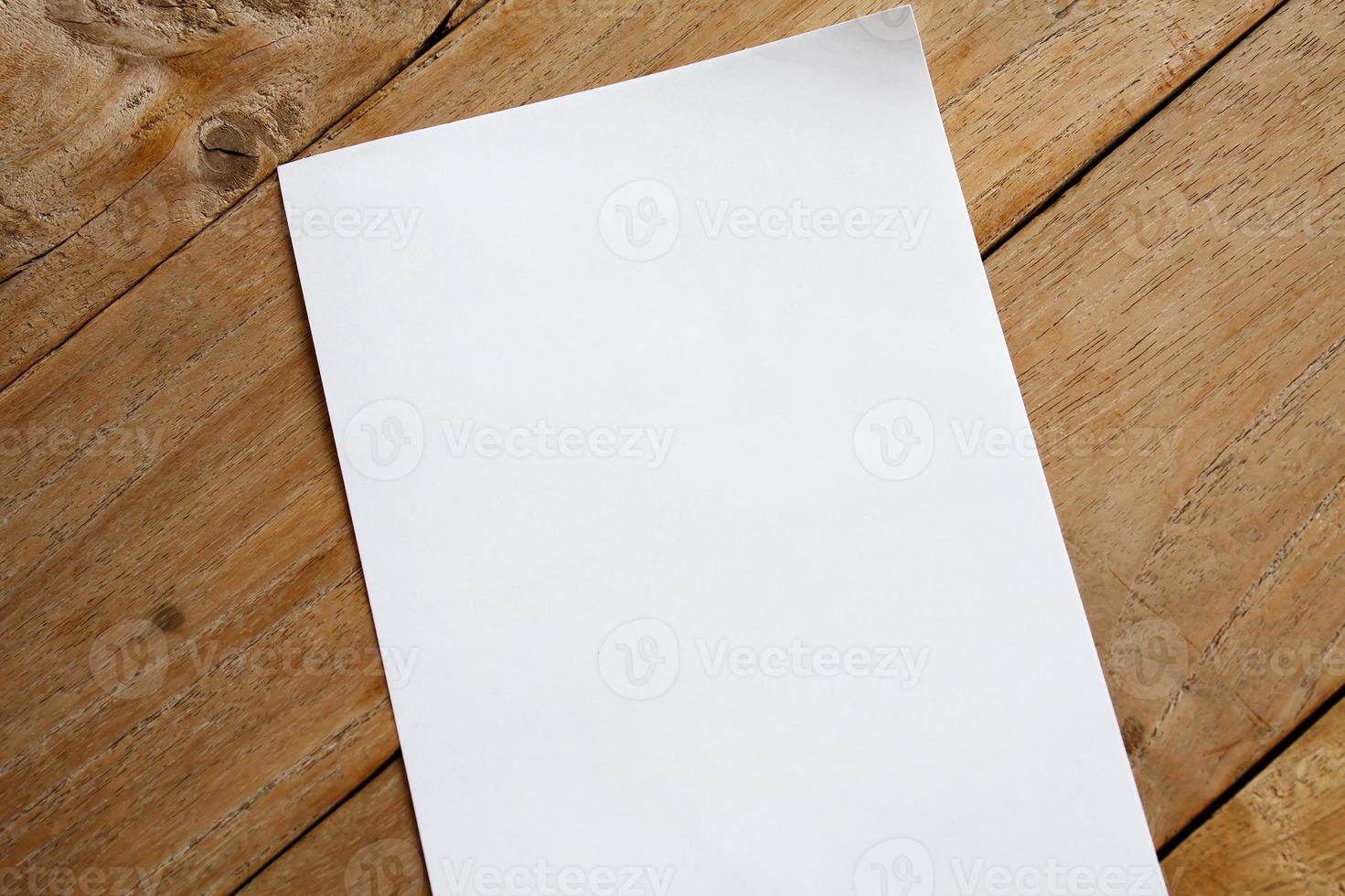 Blank paper on wood table photo